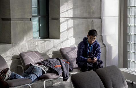 Princeton University’s Alan Du (right) and his brother rest after two days of intense programming work at the Kent Hackathon in Rockwell Hall over the weekend of Jan. 29, 2016. The brothers won a prize for their app, which aggregates customer reviews of online shops based on keyword searches.