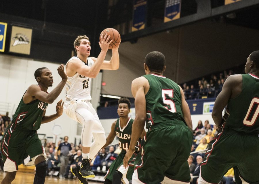 Freshman guard Mitch Peterson of the Kent State mens basketball team jumps through the Mississippi Valley State University defense on Wednesday, Nov. 16, 2016 at the M.A.C. Center.