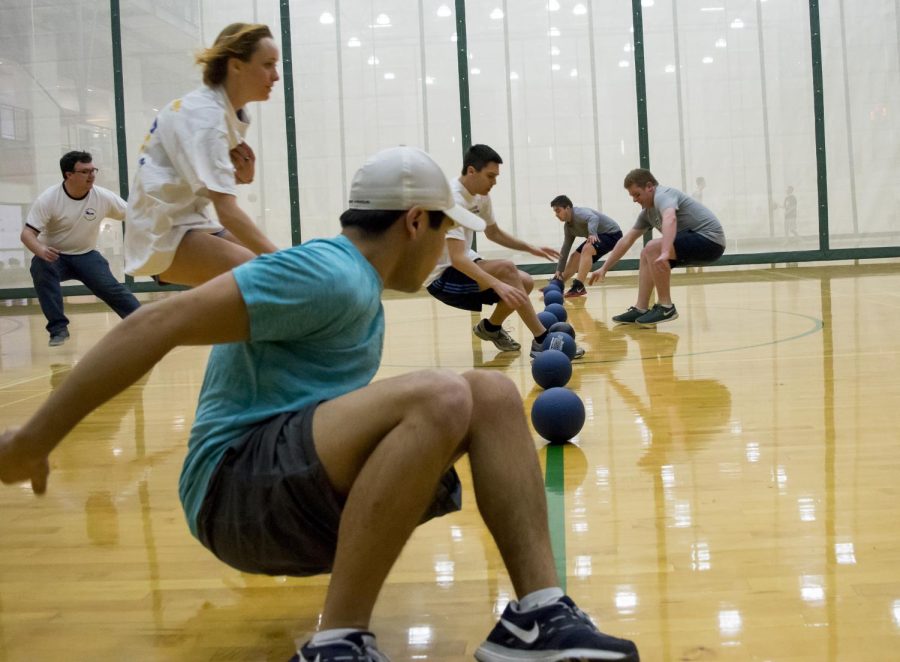 Players rush to gather balls at the beginning of the the College Democrat and Republican Dodgeball game at the Student Recreation and Wellness Center on Feb. 20, 2017.
