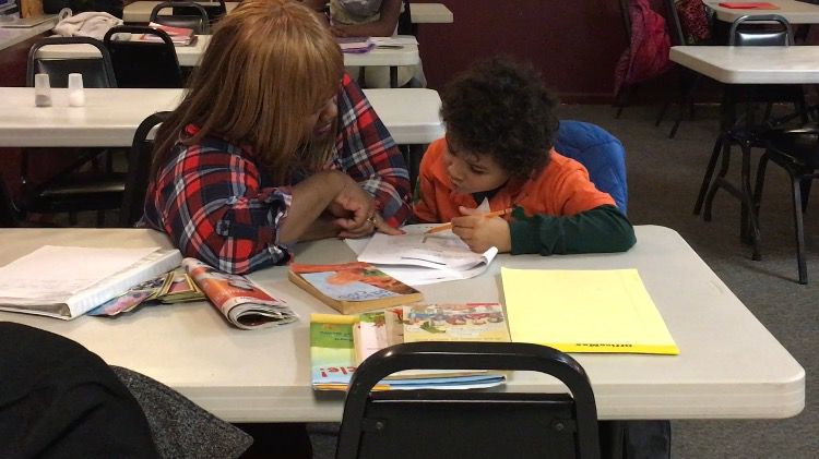 Volunteer Cynthia Alexander helps student Byron Ridenour-Wright with homework during a Homework Help session at Kent Social Services.