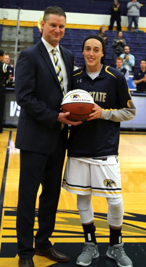 Kent States head coach Todd Starkey and senior guard Larissa Larken pose for photos on Wednesday, Nov. 30, 2016 after Larken was honored for scoring her 1,000th career point in the previous game.