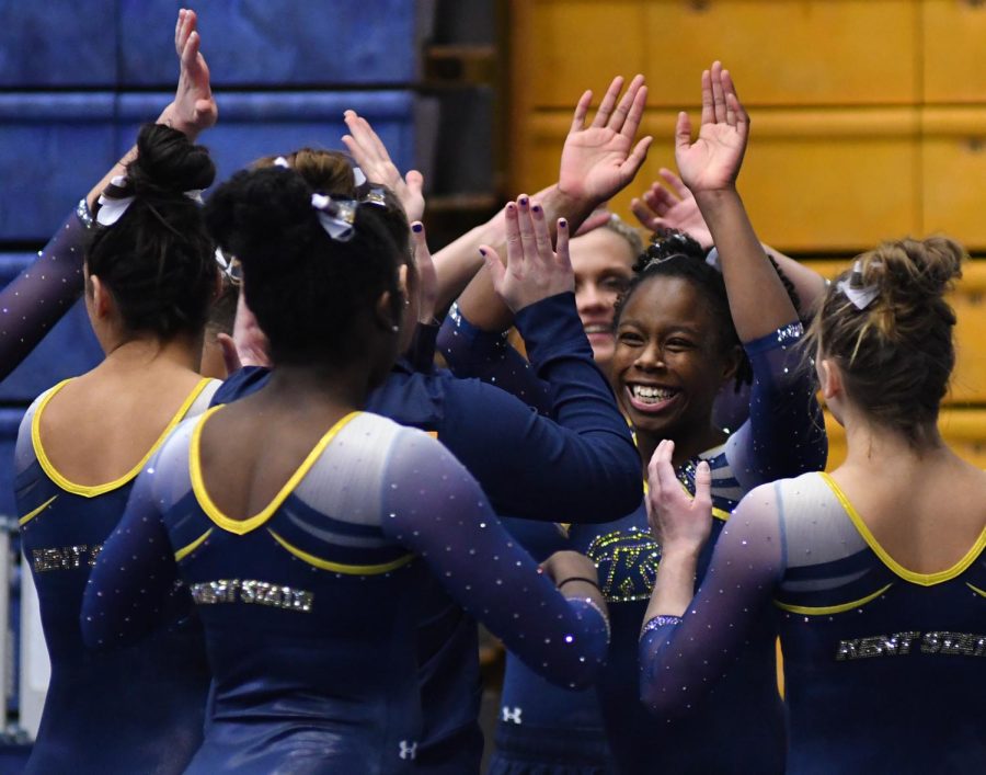 Kent+State+senior+Jordan+Hardison+celebrates+with+her+team+after+a+successful+performance+on+the+balance+beam+during+Kent+State+Universitys+Beauty+and+the+Beast+double+meet+event+for+gymnastics+and+wrestling+on+Saturday%2C+Feb.+4%2C+2017.