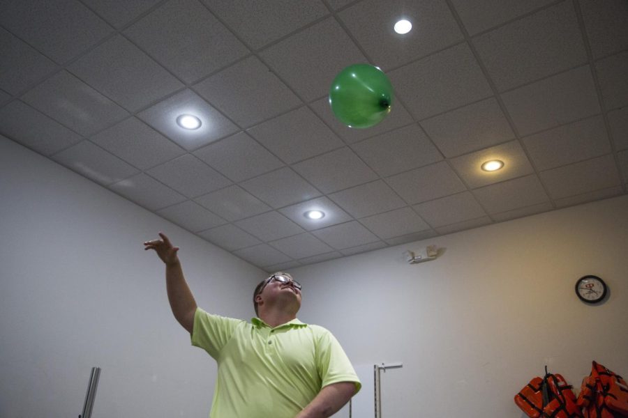 “Beau” bounces a balloon with one hand during at his physical therapy. He aims to improve the connection between his brain and damaged muscles while regaining mobility with his left leg.