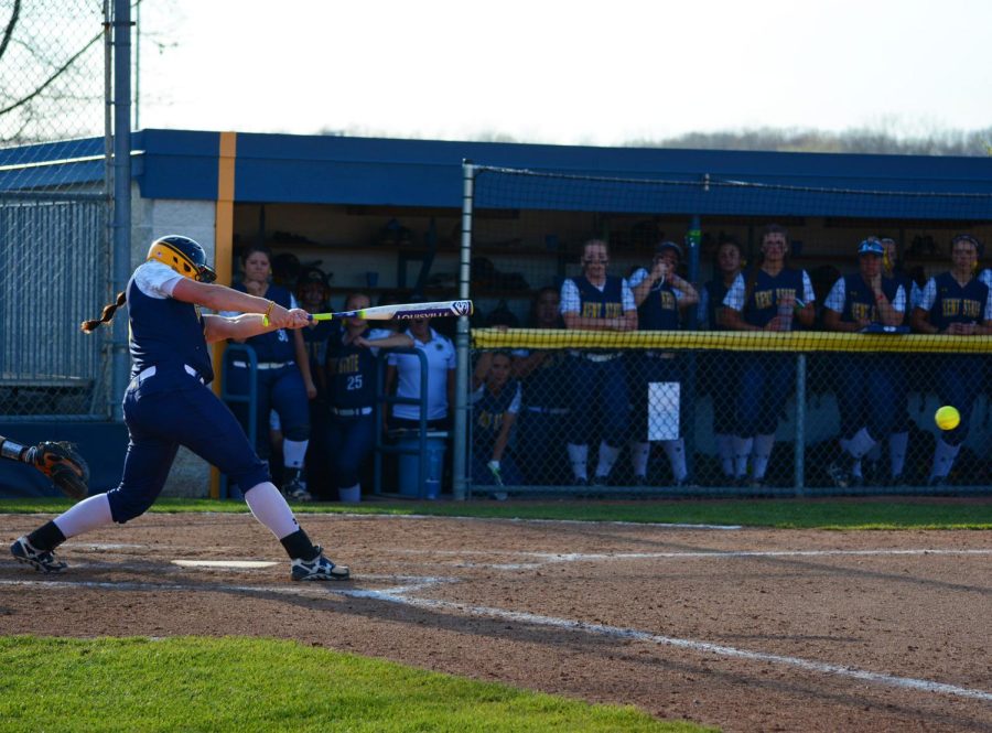 Junior infielder Maddy Grimm smashes the ball in the second game of a double header against the University of Pittsburgh Wednesday April 20, 2016. The Flashes lost 1-0 in the first game and 3-2 in the second.