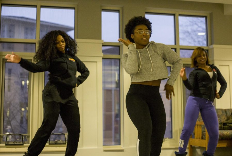 Flashettes captain Michaela Broadnax, sophomore, dances with Lacy Talley, junior, and Diamond Carroll, junior, in Centennial Court F lounge on Monday, March 20, 2017. 