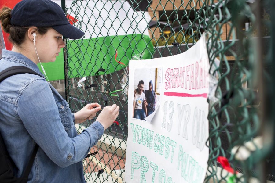 Freshman journalism major Madison MacArthur ties a ribbon to the fence as a sign of solidarity for Shadi Farah for the Israeli Apartheid Week in Risman Plaza on Monday, March 20, 2017. Farah is a 13-year-old boy serving a three-year prison sentence by the Israeli government. MacArthur was not aware about Shadi’s situation. “It’s just stuff that you don’t learn about, like I didn’t know about any of this, MacArthur said. 
