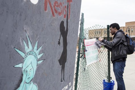 Nana Yaw Gyimah, a sophomore mathematics major, ties a ribbon to the fence as a sign of solidarity for Shadi Farah during the Israeli Apartheid Week on Monday, March 20, 2017. Farah is a 13 year old boy who is currently serving a three-year prison sentence by the Israeli government. “I definitely encourage it more because people who definitely don’t know about it are blinded to the fact, like about that all the stuff that’s going on and think their lives are all perfect, and there’s actual people going through this stuff for no reason, Gyimah said.