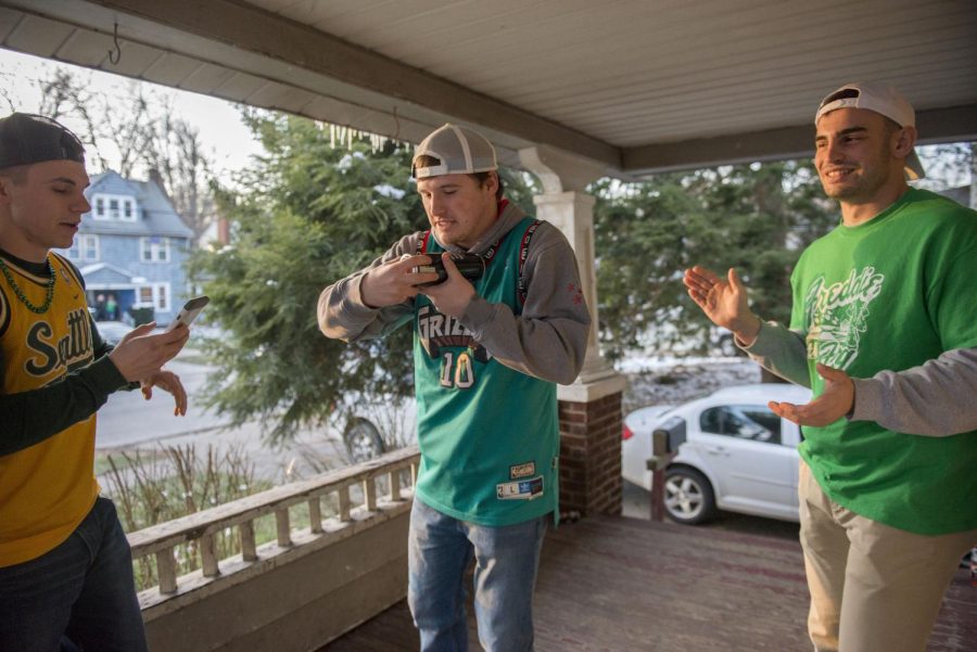 College students cheer on their friend Jake Mathie from Ohio University as he shotguns a beer on University Drive Saturday, March 11, 2017. The Kent State tradition “Fake Patty’s Day” takes place the week before St. Patrick’s Day to allow an entire Saturday to party.