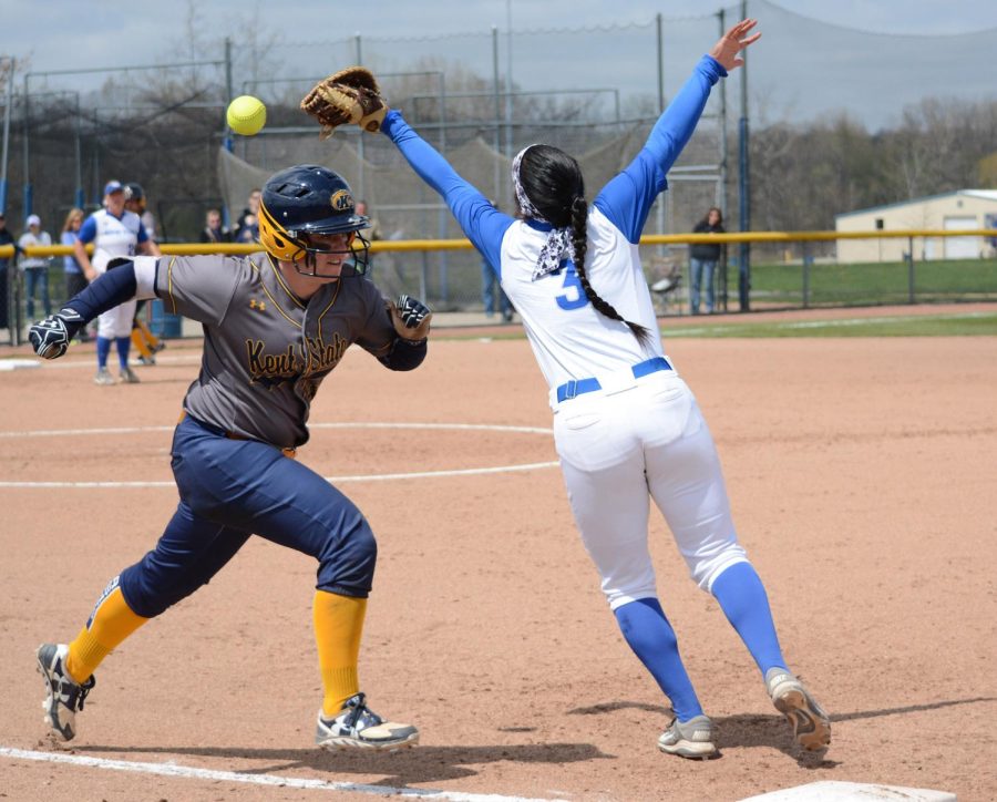 Freshman outfielder Sydney Anderson races safely to first base after the University at Buffalo player misses a passed ball in the first of their double header games on Saturday April 23, 2016. The Flashes would go on to win their first game 8-0.