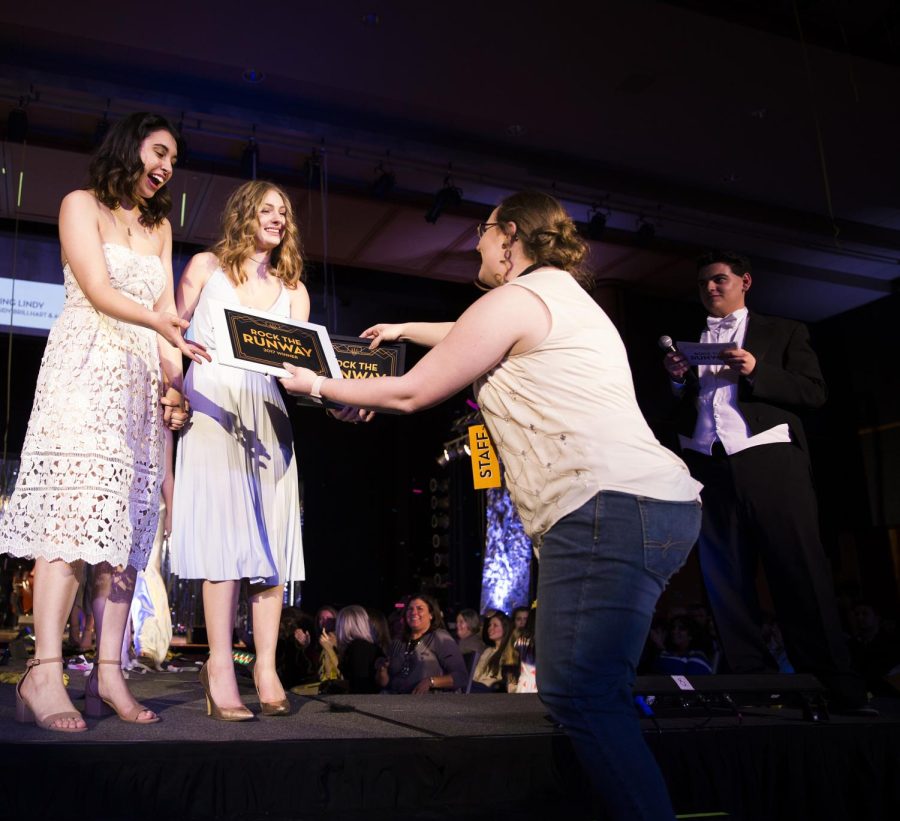 Rebecca Kapler hands the Rock the Runway awards to Ann Marie Elaban and Kassidy Brillhart, designers of the winning line Living Lindy on Saturday, March 4, 2017.