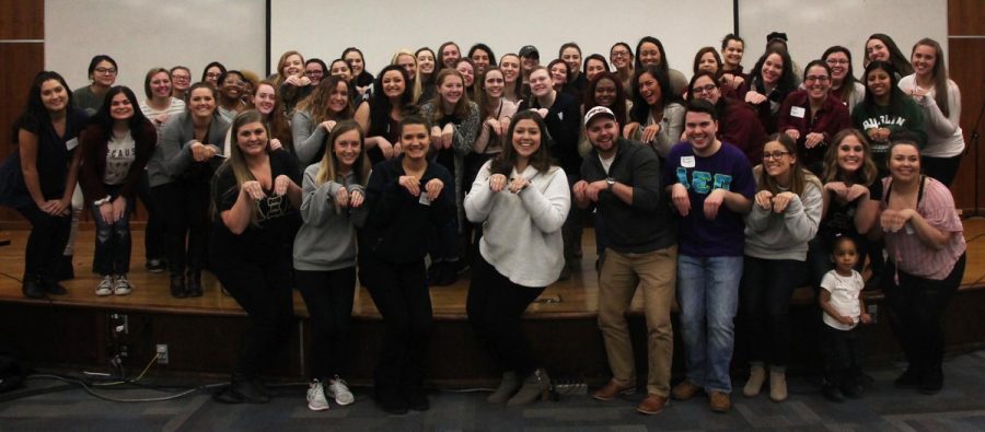 Kent State Women’s Empowerment Conference participants “squirrel squat” for a group photo on Saturday, March 18, 2017.