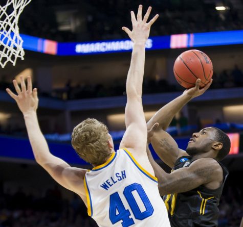 Kent State senior guard Deon Edwin attempts a layup over UCLA junior center Thomas Welsh during the first-round of the NCAA Tournament at the Golden 1 Center in Sacramento, California on Friday, March, 17, 2017. Kent State lost 97-80.