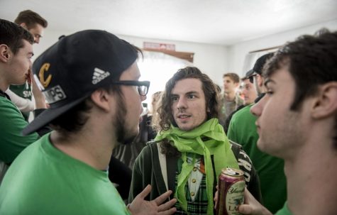 Dillen Keegan of Kirtland, Ohio, talks to partygoers at a Fake Patty’s Day house party Saturday, March 11, 2017.