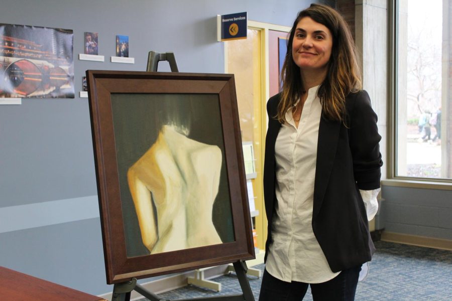Kent State alumna, Cassie Phillips, stands next to one of her pieces that she showcased at the Womens Symposium on Wednesday, March 1, 2017.