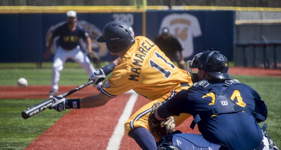 Alexander Wadley / The Kent Stater Redshirt junior Mason Mamarella bunts the ball to advance to first base. The Flashes swept the Rockets with a final score of 10-1 in the game April 23, 2017.