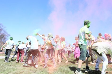 Participants of the Kent Indian Association (KIA) sponsored Holi festival of colors event cover each other in powdered color on Manchester Field on Saturday, April 8, 2017.