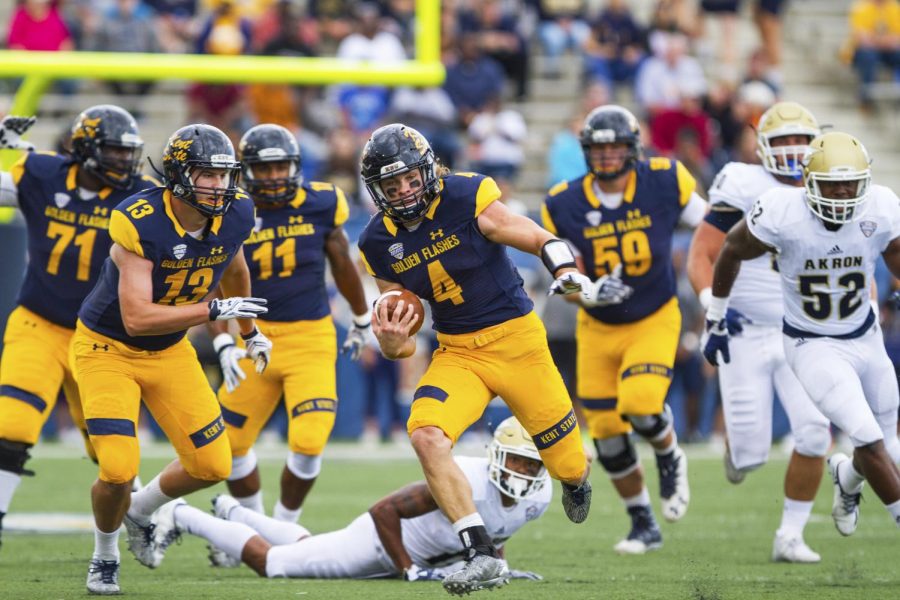 Kent State junior quarterback Nick Holley runs down field against Akron at Dix Stadium on Saturday, Oct. 1, 2016. Kent State lost 31-27.