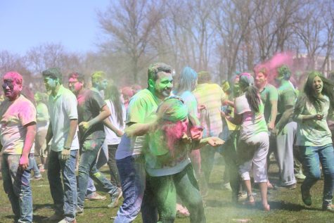 Participants of the Holi festival of colors event cover each other in powdered color on Manchester Field on Saturday, April 8, 2017.