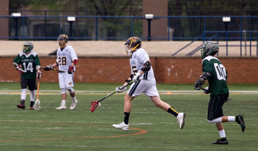 Buzzelli (center) as a long stick midfielder against Cleveland State in the conference semifinals April 29. 