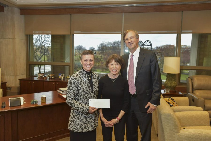 Kent State University President Beverly Warren (left) receives a $1 million grant for the university’s Institute for Applied Linguistics from Mary and Ted Gawlicki of the Gawlicki Family Foundation.