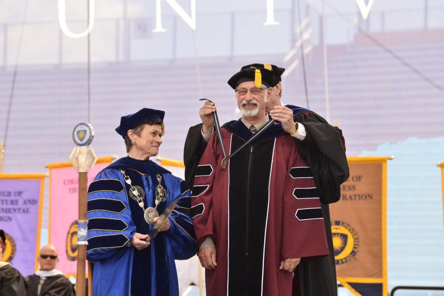 Todd+Diacon%2C+Kent+State%E2%80%99s+senior+vice+president+for+academic+affairs+and+provost%2C+places+the+President%E2%80%99s+Medal+on+Distinguished+Professor+of+Human+Evolutionary+Studies+C.+Owen%C2%A0Lovejoy%C2%A0as+Kent+State+President+Beverly+Warren+watches.