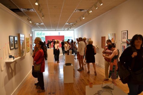 Attendees peruse art at the Downtown Gallerys event “You, Me, Us, We” benefiting Planned Parenthood of Ohio Thurs., June 29, 2017.