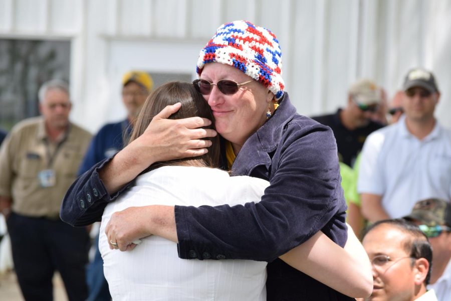Heather Scarlett (left) shares an emotional hug with her mother Darlene Scarlett (right) at the ceremony commemorating father and husband Lonnie Scarlett.