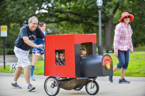 Dennis and Cheryl Dendinger push their grandchildren Charlotte and Harrison in their homemade Hogwarts Express stroller at the Potterfest 5k on July 28. It took three days to build but Harrison really loves trains and Harry Potter, says Dennis Dendinger. 