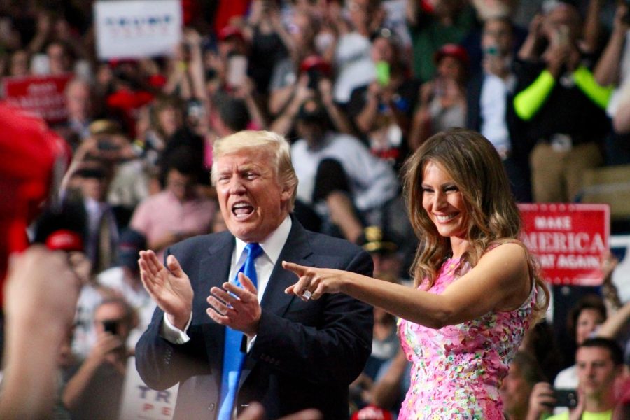 President Donald Trump and First Lady Melania Trump enter the stage to give their speeches at the Covelli Centre in Youngstown, Ohio, on Tuesday, July 25, 2017. 