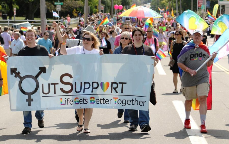 Members of OutSupport Inc. march during the Akron Pride parade on Saturday, Aug. 26, 2017.