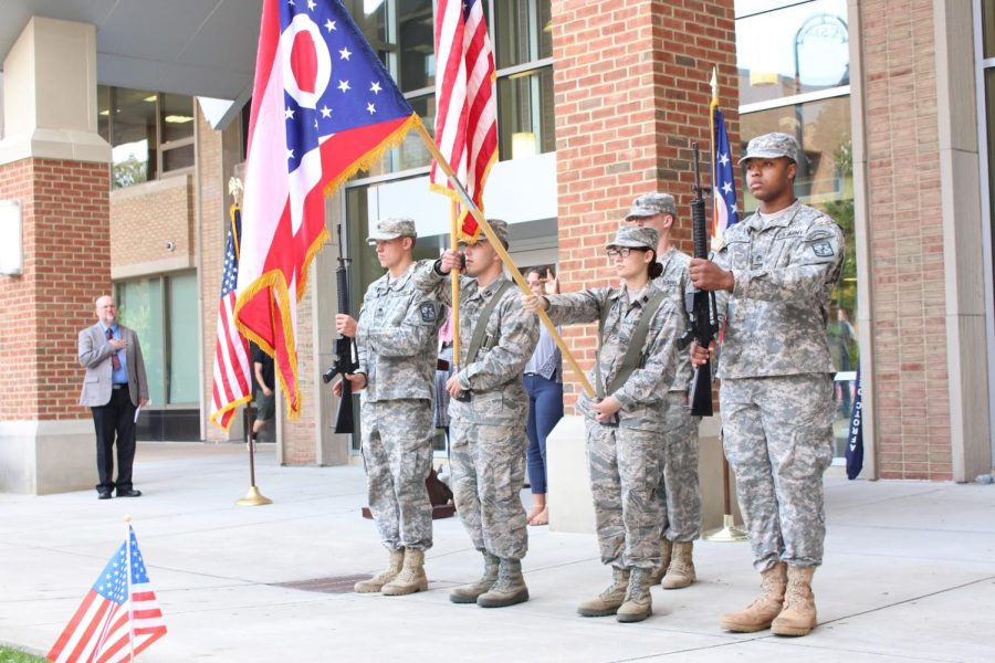 Honor Guard members hold the American and Ohio state flag outside the University Library during the university’s Constitution Day ceremony