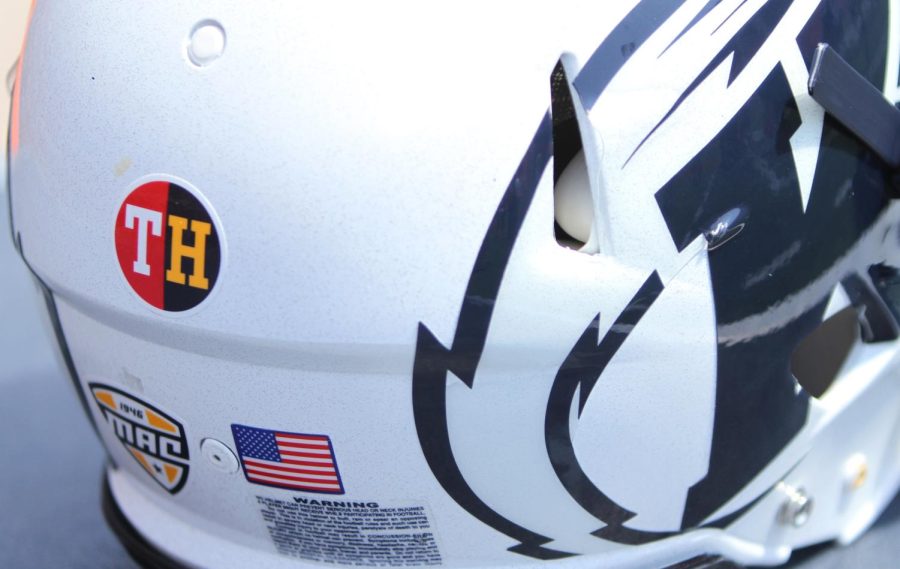 A Kent State helmet sits on the sideline adorned with a sticker for Tyler Heintz, a freshman lineman who passed away this summer during the teams conditioning. 