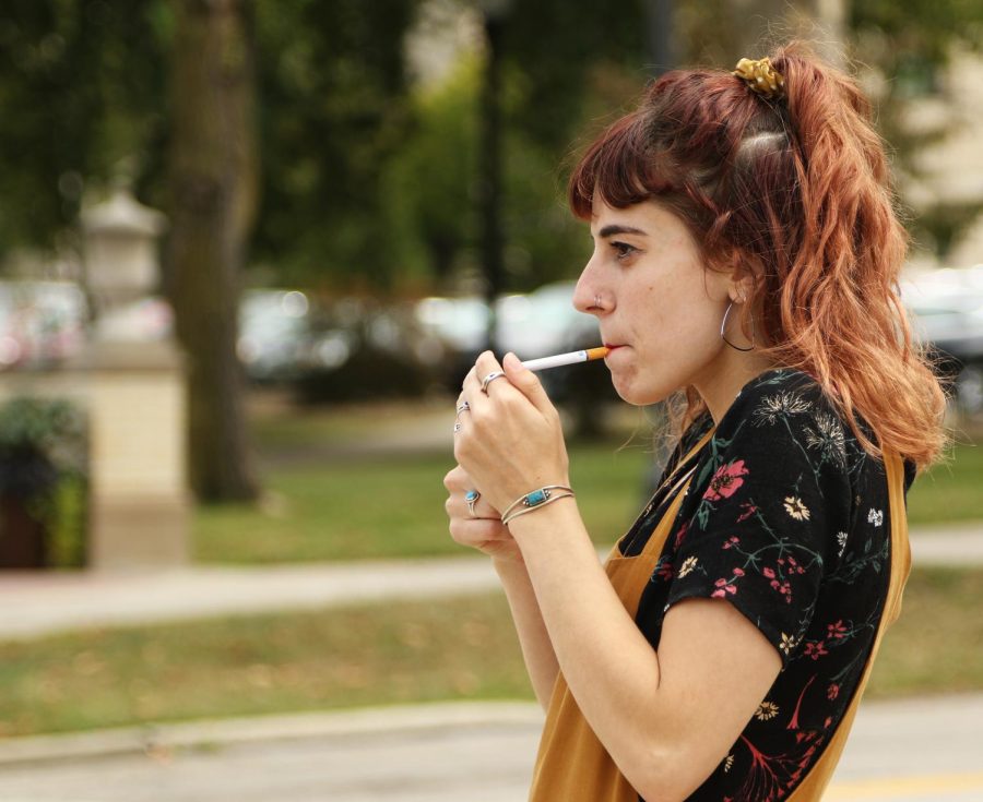 Natalie Frank, a senior art education major, smokes a cigarette off campus Thursday, Aug. 31, 2017. Kent State banned smoking and tobacco use July 1.