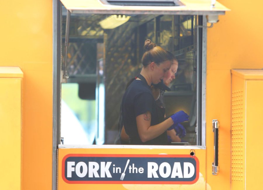 Employees serve samples of pulled pork from Fork in the Road food truck during Taste of Kent in Risman Plaza on Wednesday, Sept. 20, 2017.