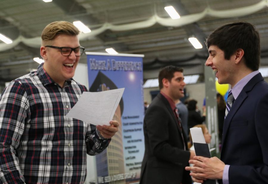 Kent State marketing graduate Nick Yopko (right) speaks to Kent State graduate and Geometry Global project coordinator Ryan Kekela (left) about job opportunities during the Spring Internship, Co-op and Career Fair held in the Kent State Field House on Thursday, Feb. 23, 2017. “I’m looking for something that uses my skills that I’ve gained from school for some stability,” said Yopko.