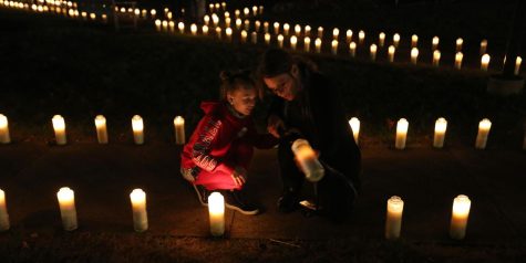 Emma, 7, (left) and Heather Phillips relight a candle outside the Tallmadge church in Tallmadge, Ohio, on Sept. 11, 2017. Tallmadge Fire Chief Michael Passarelli and firefighter Jeff Quick organize the event every year to commemorate the terrorist attacks on Sept. 11, 2001.