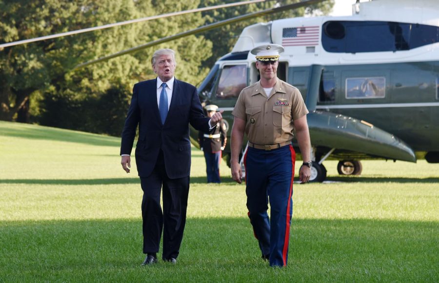 President Donald Trump walked toward the White House with pilot James Thompson Jr., who completed his last Marine One flight, on the South Lawn of the White House in Washington on Sunday, Sept. 24, 2017.