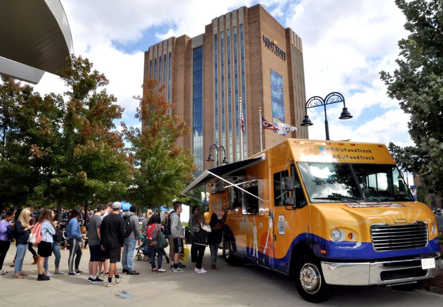 Students stand in line for the Fork in the Road food truck during Black Squirrel Festival on Friday, Sept. 8, 2017.