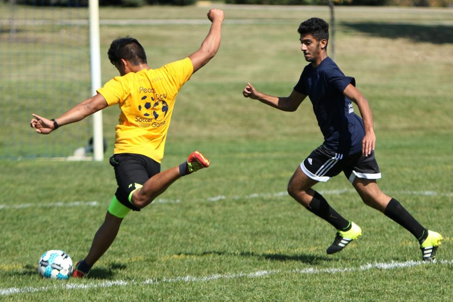 Graduate student Niranjan Rai attempts to kick a goal during the Kent State International Day of Peace soccer game on Saturday, Sept. 23, 2017. The gold team, comprised primarily of international students, beat the blue team, comprised primarily of international scholars, 5-3.