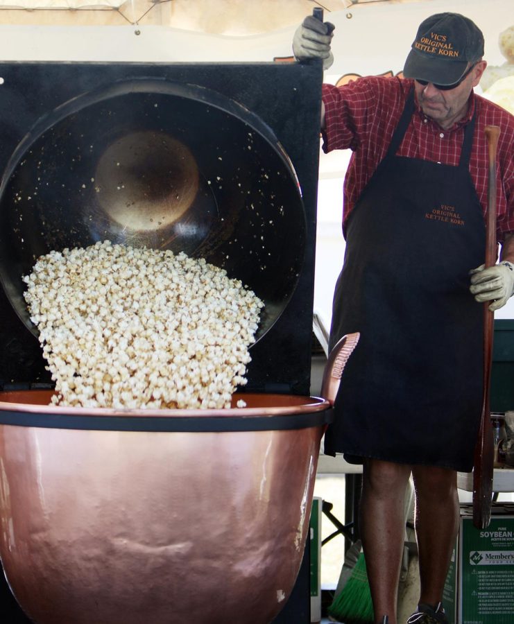 Elden Wells, 62, of Brimfield, Ohio, dumps a popcorn into a copper kettle during Brimfest. After a decade-long scheduling conflict, Wells finally participated in Brimfest. “It’s all about supporting the community,” said Vickie, Eldens wife.