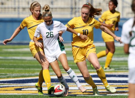 Kent State junior defender Paige Culver (#10) battles for the ball against Eastern Michigan on Sept. 23, 2017.