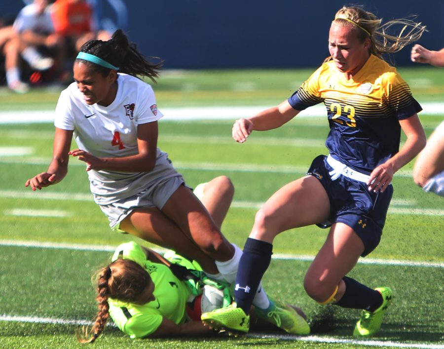 Bowling Green sophomore goalkeeper Victoria Cope slides to protect the ball from Kent State freshman defender Karly Hellstrom during a game at Dix Stadium Sunday, Oct. 22, 2017. The Flashes lost 3-1.