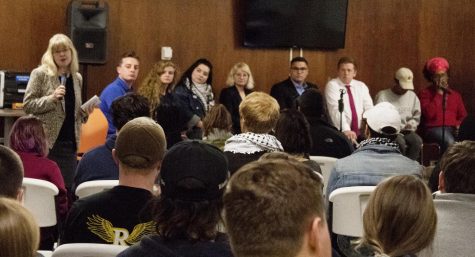 Panelists turn to listen to Amy Reynolds, the dean of the College of Communication and Information, as she speaks on the history of free speech at the KENTtalks series Wednesday, Oct. 18, 2017.
