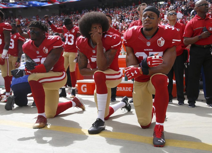 From left, San Francisco 49ers Eli Harold (58), quarterback Colin Kaepernick (7) and Eric Reid (35) kneel during the national anthem before their NFL game against the Dallas Cowboys on Sunday, Oct. 2, 2016 in Santa Clara, Calif.