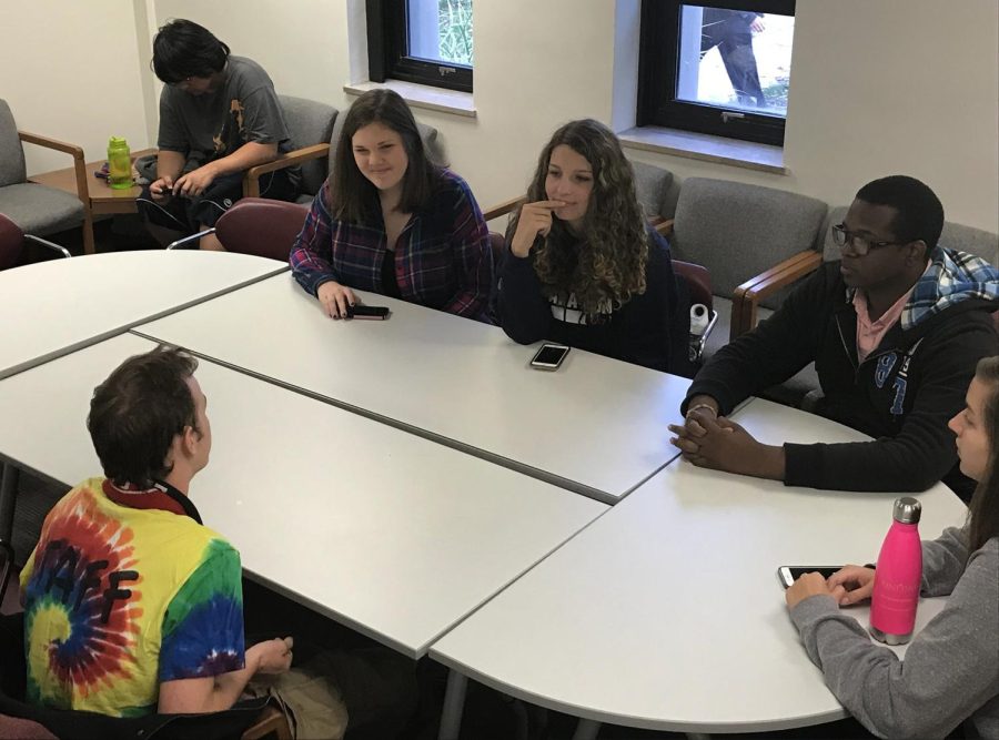 Students sit around a table and speak Spanish during coffee hours in Satterfield Hall Thursday, Oct. 26, 2017.