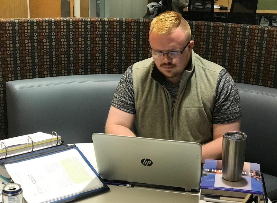 Evan Faidley, a graduate student in college teaching, types his proposal for his dissertation during the Dissertation Boot Camp in the University Library on Sunday, Oct. 8 2017 .