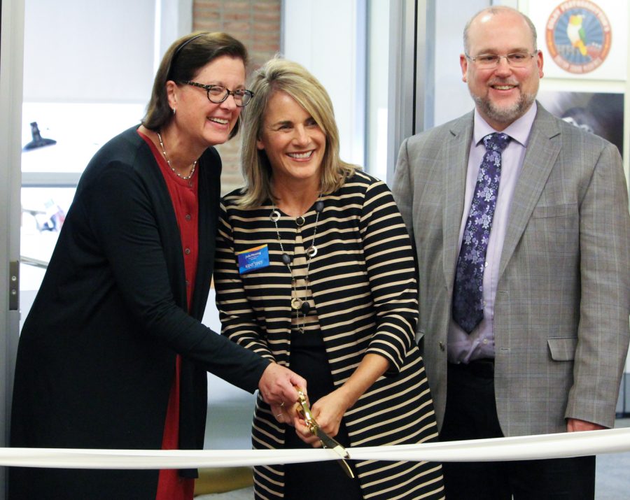 Deborah Hoover, the president of the Burton D. Morgan Foundation (left), Julie Messing, the executive director of NeoLaunchNET (center) and Ken Burhanna, the interim dean of University Libraries, cut the ribbon for the new LaunchNET offices on Sept. 29, 2017.