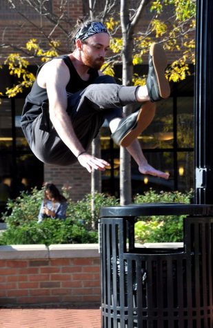 Forrest Paige, the creator of the Kent Parkour Klub, practices his skills outside the Student Center Friday, Oct. 13, 2017.