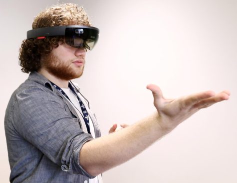 Jack Plank, a junior engineering major at Ohio State University, uses a Microsoft HoloLens during a demonstration of his group’s drone program prototype designed to inspect the power grid after natural disasters.