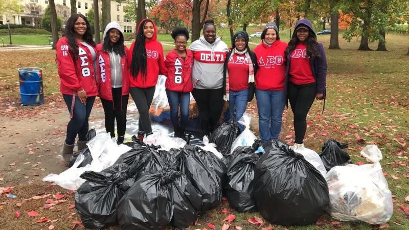 Delta Sigma Theta sorority poses with trash bags after helping to clean up downtown following Kent Halloween on Sunday, Oct. 29. 